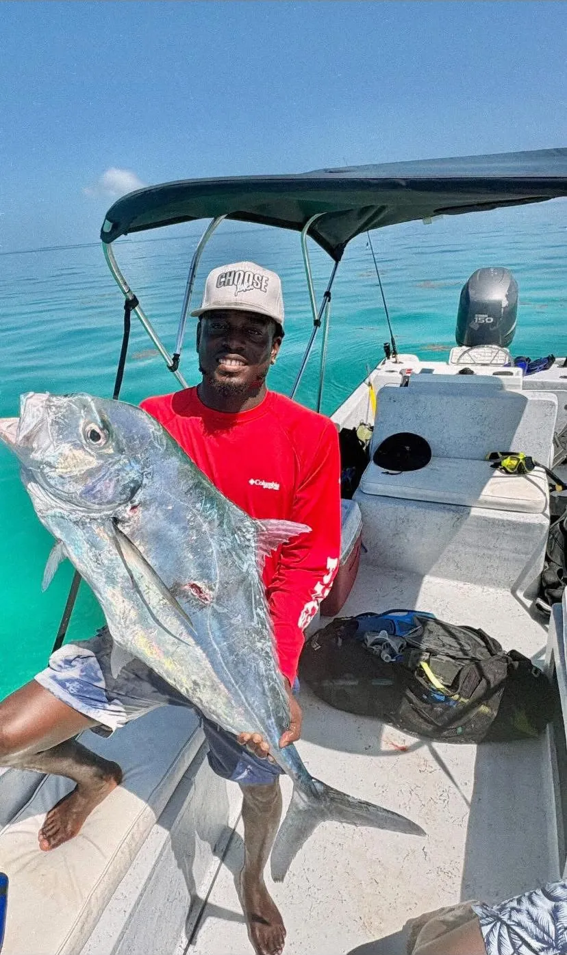 Captain Jamar on his boat holding a big jack